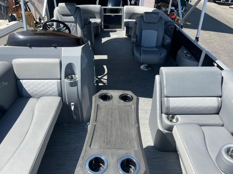 Slide: The Image of 2022 Bennington 23 L pontoon boat interior with gray seating and cup holders. - 19