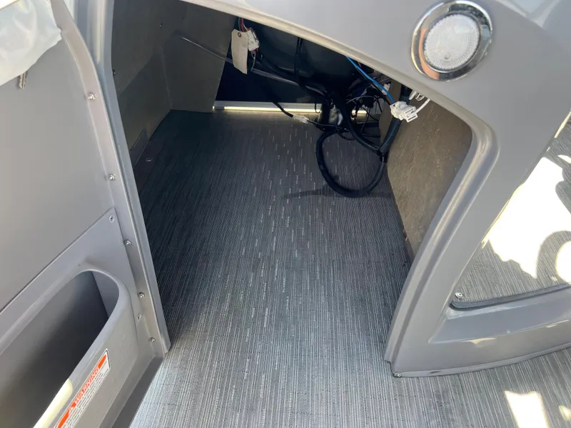 Slide: The Image of Interior view of 2022 Bennington 23 L boat showing storage compartment. - 22