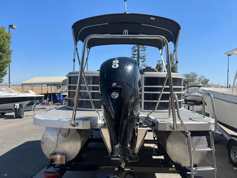 Slide: The Image of 2022 Bennington 23 L pontoon boat with outboard motor in marina. - 6