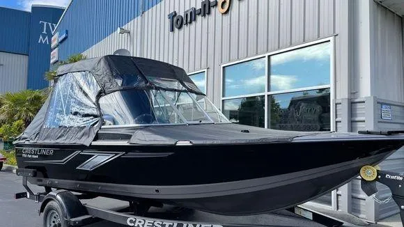 The Image of 2023 Crestliner 1750 Fish Hawk boat displayed outside a dealership. - 0