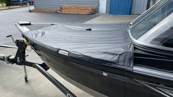 Slide: The Image of 2023 Crestliner 1750 Fish Hawk boat with a black cover on a trailer. - 3