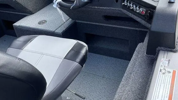Slide: The Image of 2023 Crestliner 1750 Fish Hawk boat interior with captain's chair and control panel. - 4