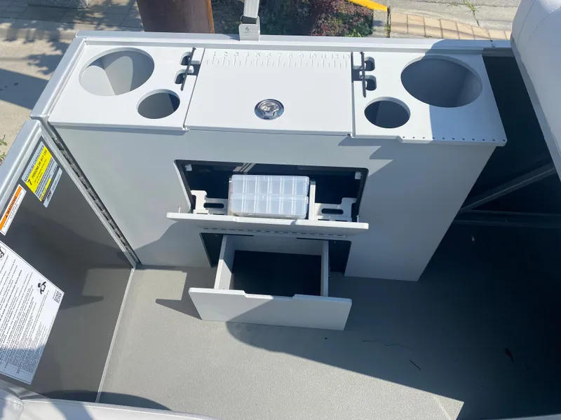 Slide: The Image of 2023 Godfrey MIGHTY G 1476F boat console with storage compartments and cup holders. - 10