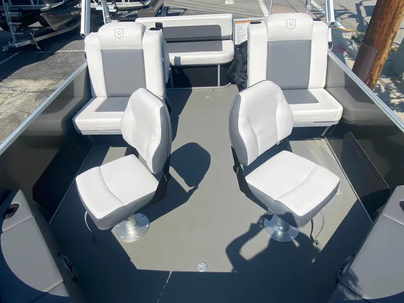 Slide: The Image of 2023 Godfrey MIGHTY G 1476F boat interior with four white seats. - 4