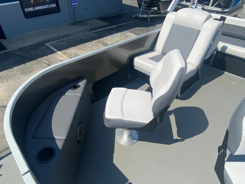 Slide: The Image of 2023 Godfrey MIGHTY G 1476F boat interior with two grey seats and storage compartment. - 5