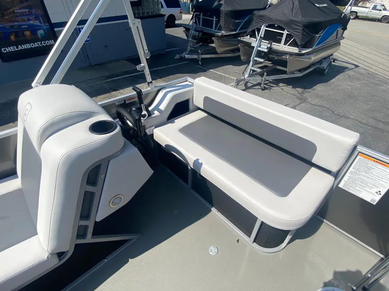 Slide: The Image of 2023 Godfrey MIGHTY G 1476F boat interior with seating and control console. - 7