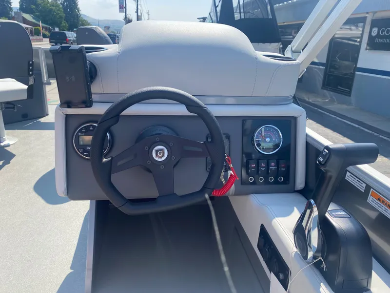 Slide: The Image of 2023 Godfrey MIGHTY G 1476F boat dashboard with steering wheel and control panel. - 8