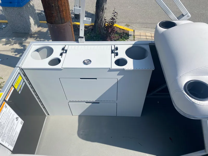 Slide: The Image of 2023 Godfrey MIGHTY G 1476F boat interior with storage compartments and cup holders. - 9