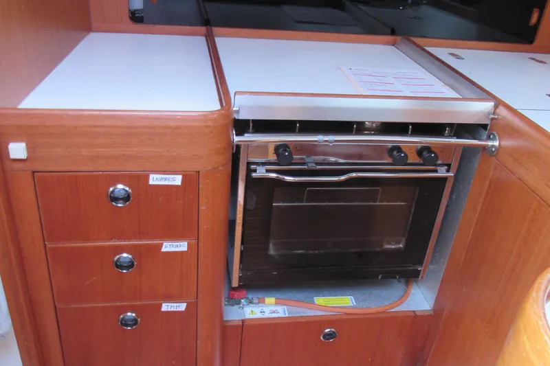 Slide: The Image of Galley kitchen in 2000 X-Yachts X-412 sailboat with oven and storage drawers. - 10