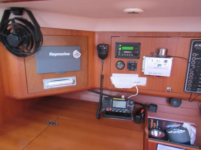 Slide: The Image of Navigation equipment on 2000 X-Yachts X-412 sailboat, featuring Raymarine systems and communication devices. - 12