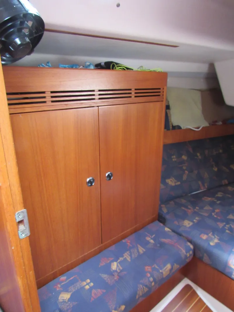 Slide: The Image of Interior cabin of 2000 X-Yachts X-412 with wooden cabinetry and patterned seating. - 14
