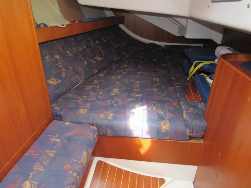 Slide: The Image of Cozy cabin interior of 2000 X-Yachts X-412 with patterned cushions and wooden accents. - 15