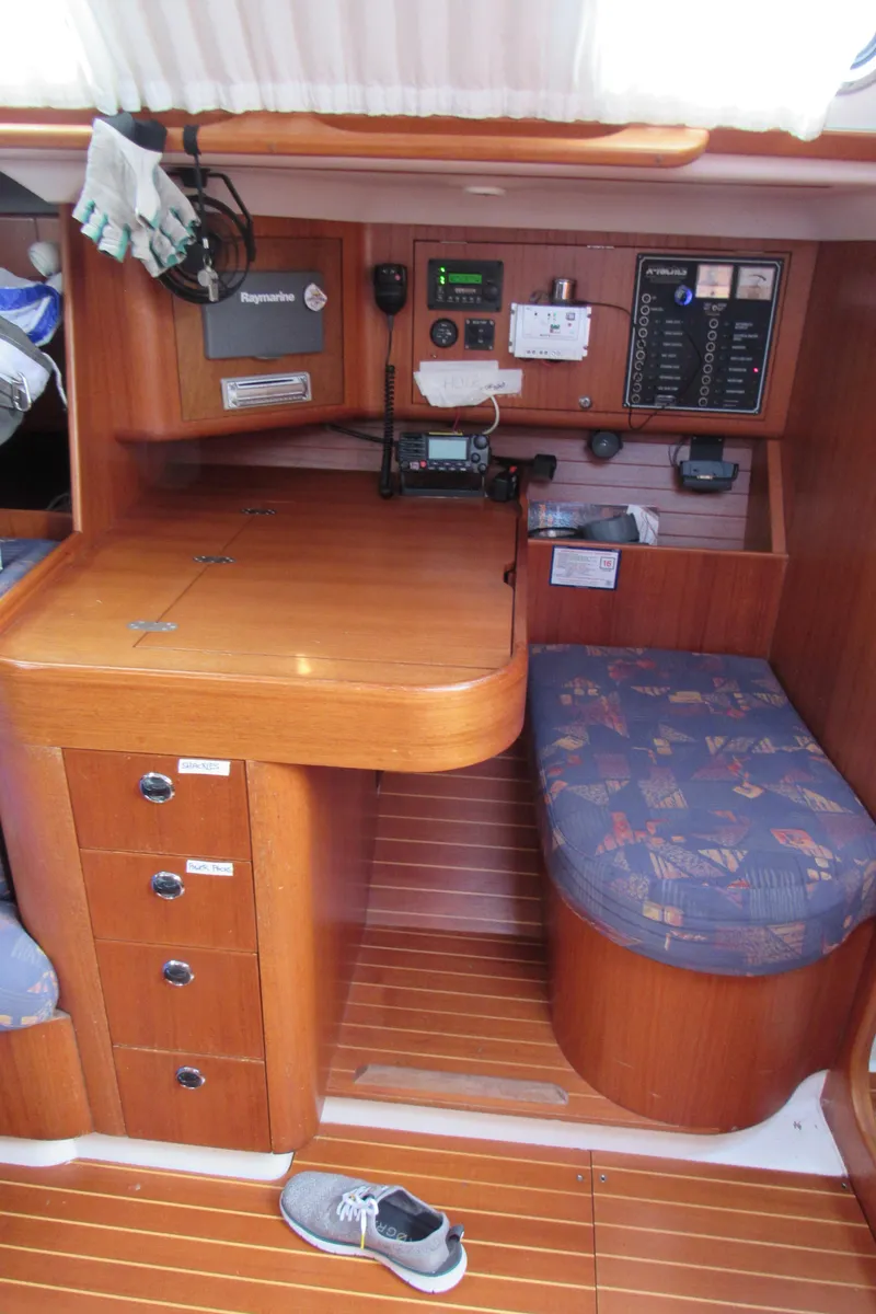 Slide: The Image of Navigation station of 2000 X-Yachts X-412 with wooden cabinetry and control panels. - 16