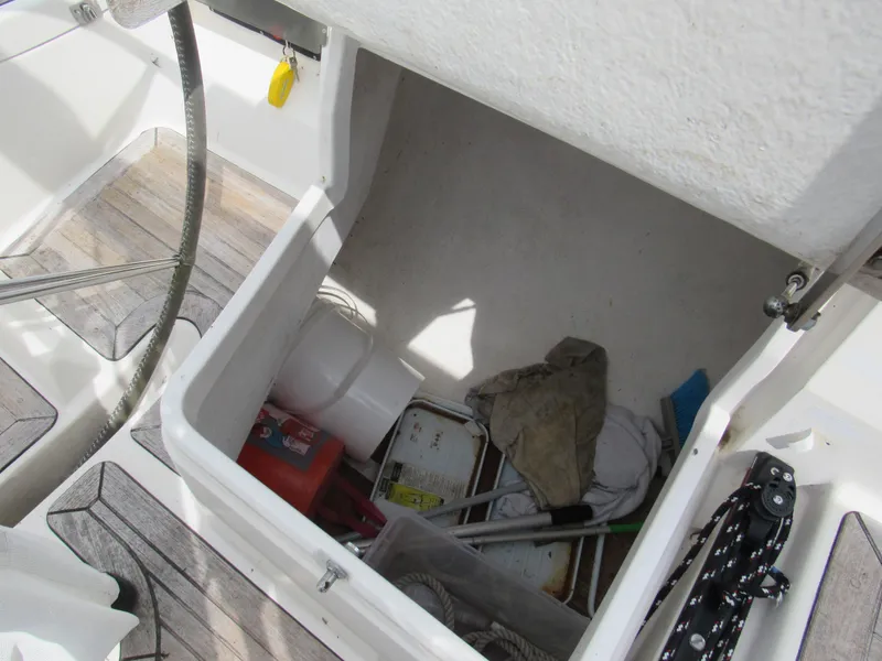 Slide: The Image of Storage compartment on a 2000 X-Yachts X-412 sailboat with various items inside. - 22