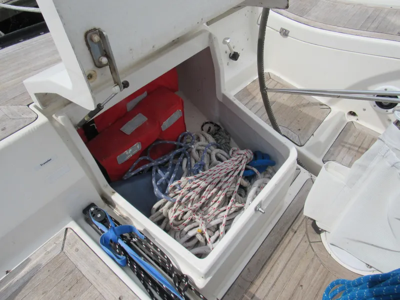 Slide: The Image of Open storage compartment on 2000 X-Yachts X-412 sailboat with ropes and red boxes. - 23