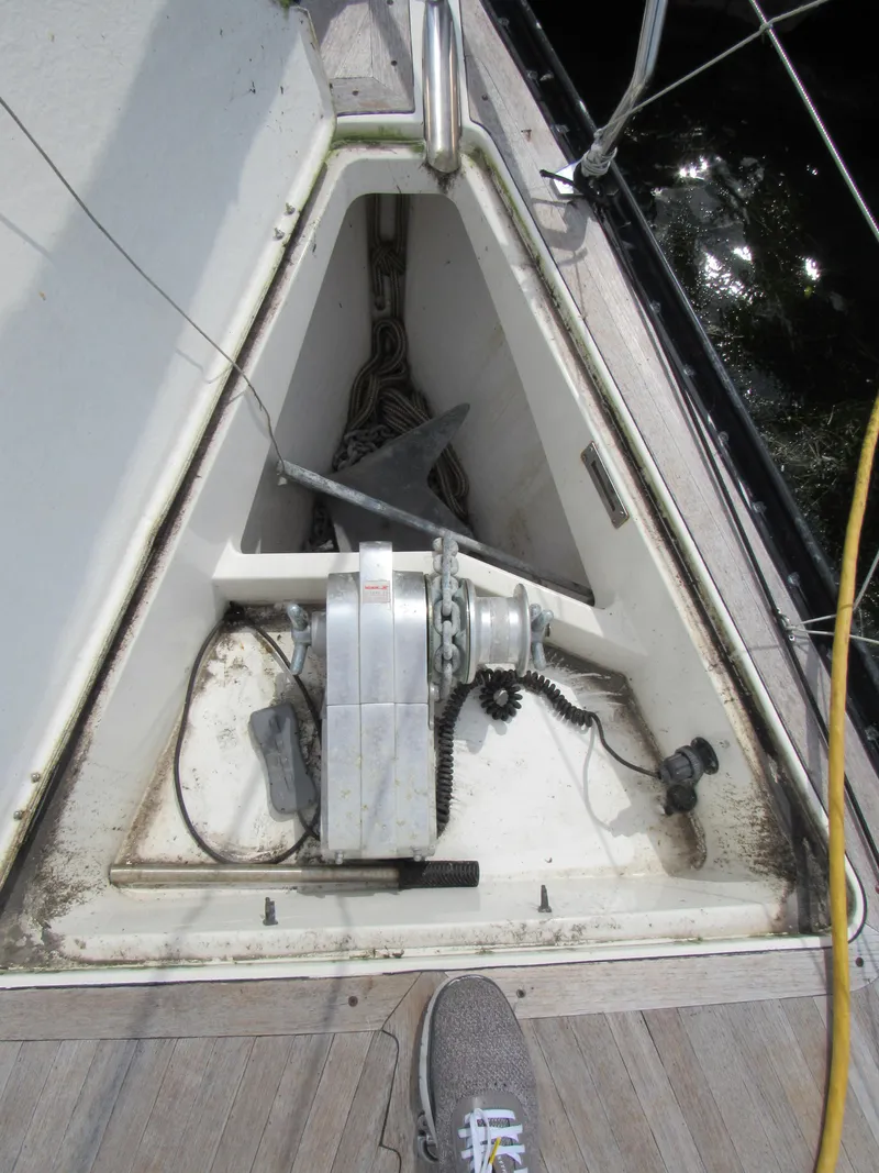 Slide: The Image of Anchor locker of 2000 X-Yachts X-412 sailboat with visible anchor and chain. - 25