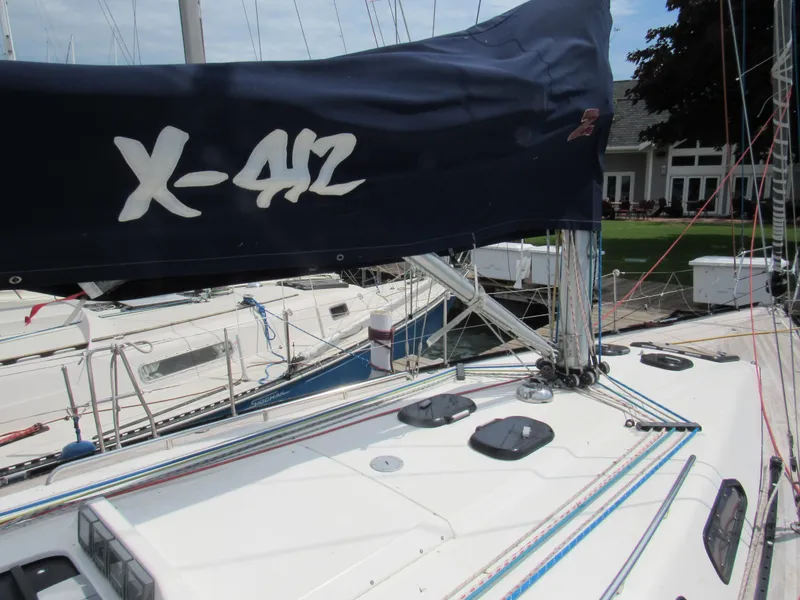 Slide: The Image of Sailboat X-Yachts X-412, 2000 model, docked with visible rigging and sail cover. - 27