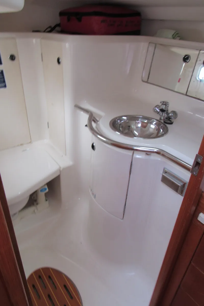Slide: The Image of 2000 X-Yachts X-412 yacht bathroom with sink, toilet, and wooden floor detail. - 34