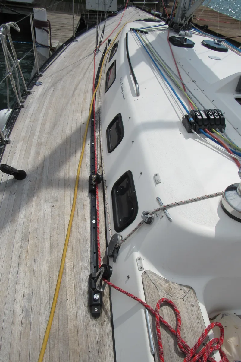 Slide: The Image of 2000 X-Yachts X-412 sailboat deck with ropes and hatches, docked at marina. - 38