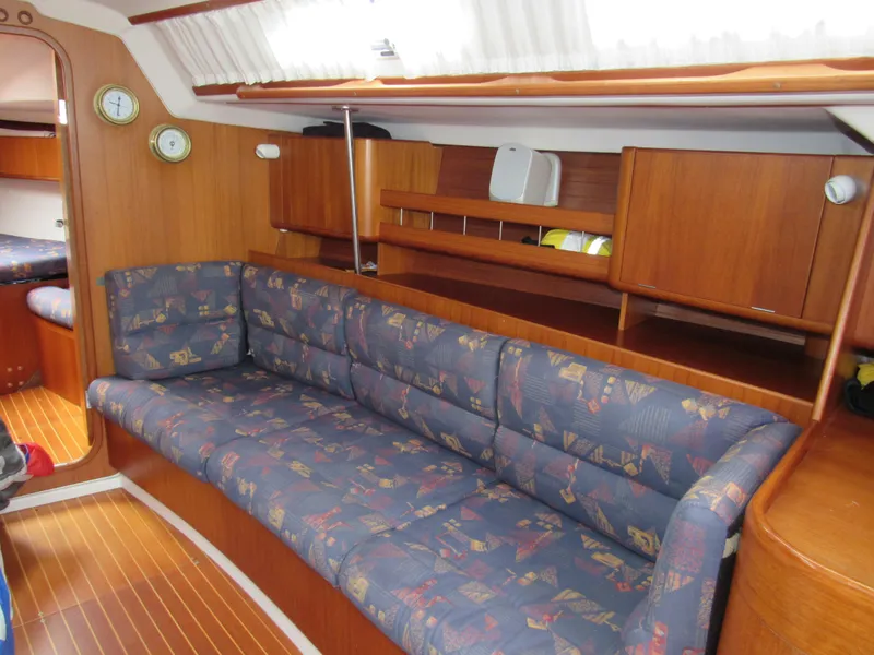 Slide: The Image of Interior of 2000 X-Yachts X-412 sailboat with patterned sofa and wooden cabinetry. - 4