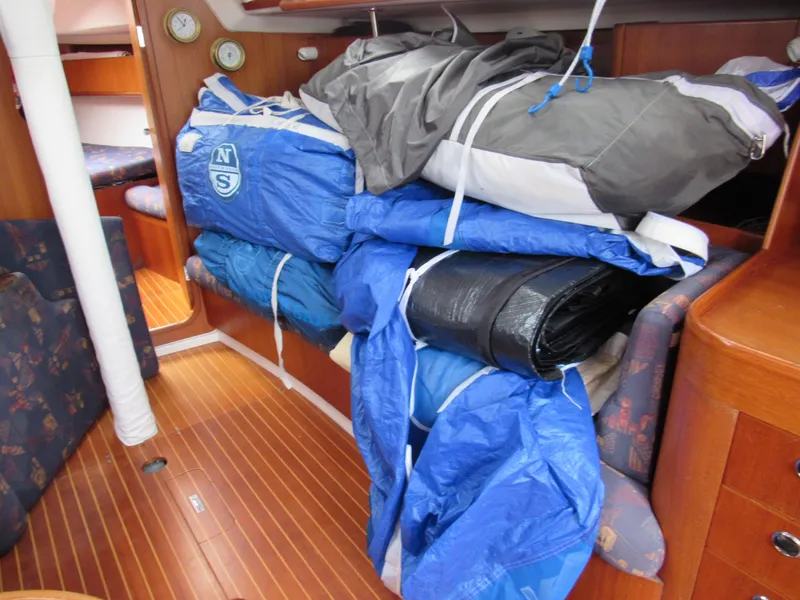 Slide: The Image of Interior of 2000 X-Yachts X-412 with sails and equipment stored on wooden floor. - 40