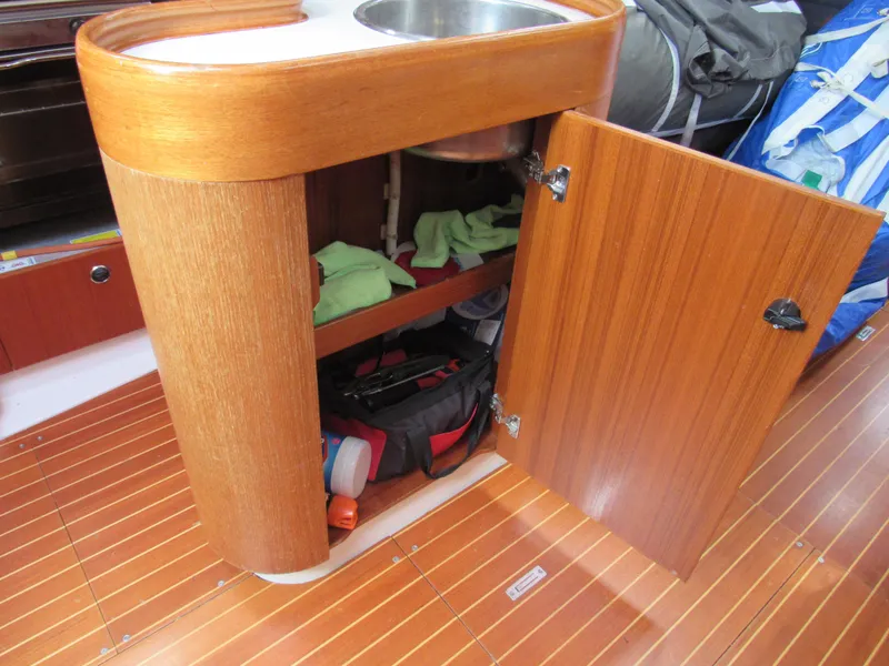 Slide: The Image of Wooden cabinet with open door and sink on X-Yachts X-412, 2000 model. - 9