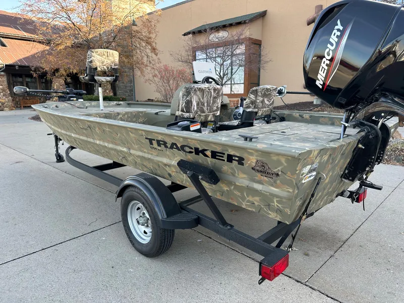 Slide: The Image of 2023 Tracker Grizzly 1754 SC boat with Mercury engine on trailer. - 2