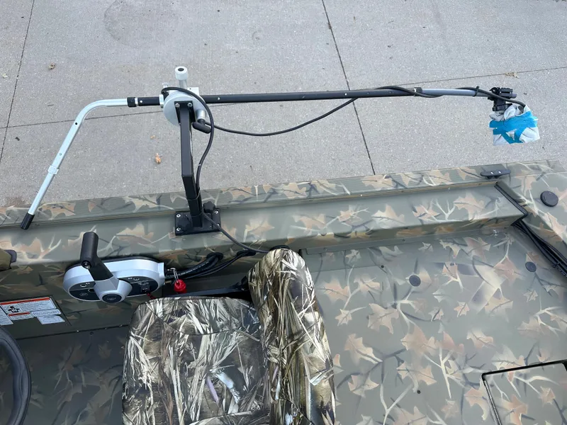Slide: The Image of 2023 Tracker Grizzly 1754 SC boat with camo seat and fishing rod holder. - 5