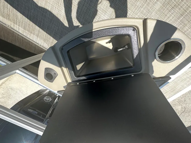 Slide: The Image of 2024 Ranger Reata 200F boat console with storage compartment and cup holder. - 10