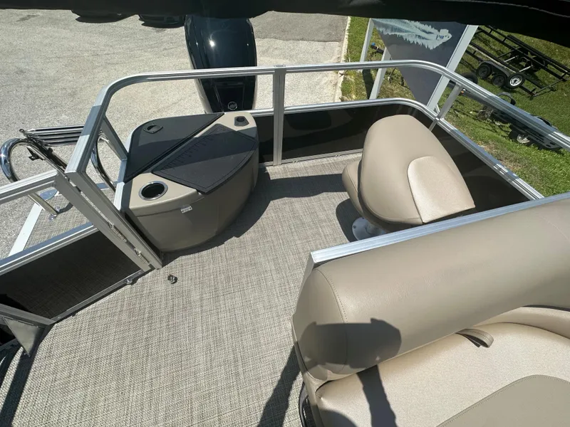 Slide: The Image of 2024 Ranger Reata 200F boat interior with beige seating and carpeted floor. - 5