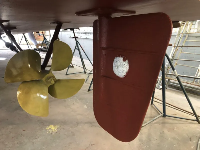 Slide: The Image of Close-up of 1972 Trumpy 72 Houseboat propeller and rudder during maintenance. - 10