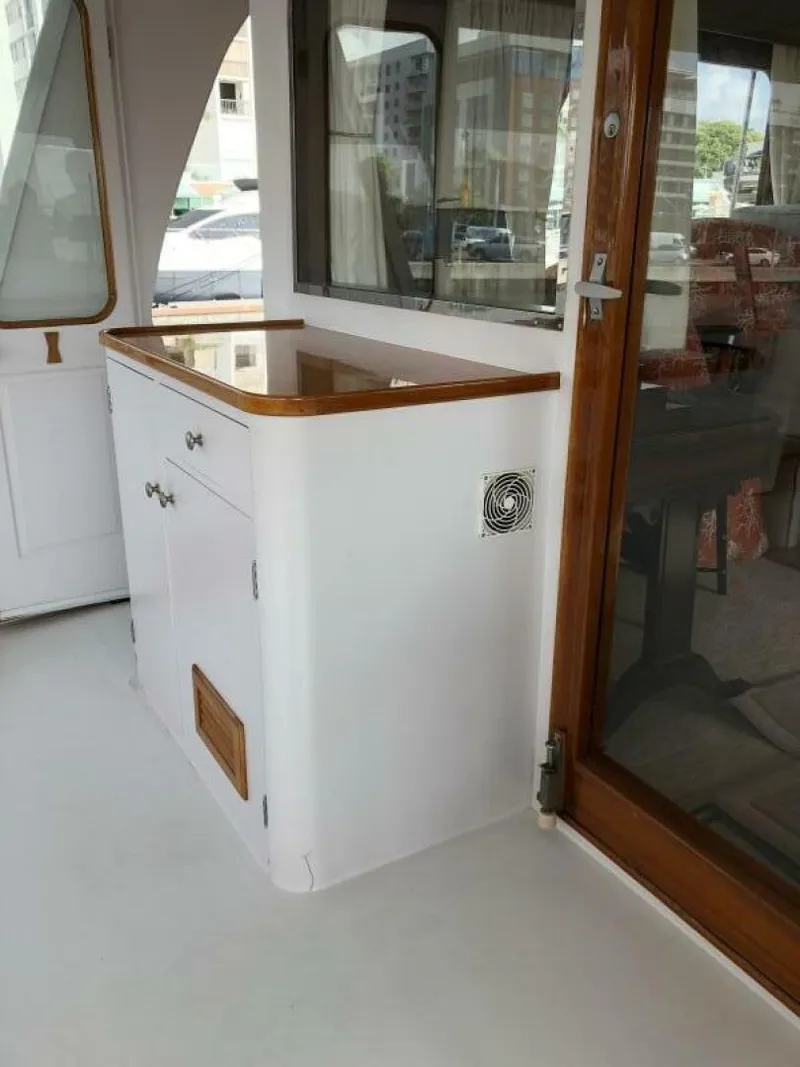 Slide: The Image of 1972 Trumpy 72 Houseboat interior with wooden accents and cabinetry. - 12