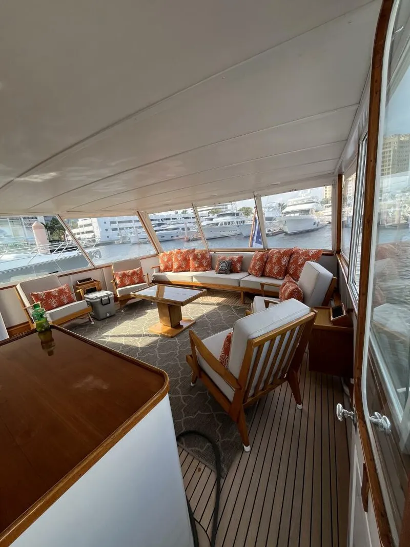 Slide: The Image of Spacious interior of a 1972 Trumpy 72 Houseboat with comfortable seating and panoramic windows. - 13