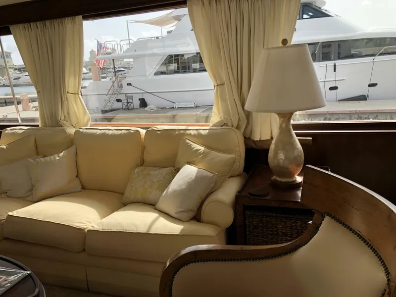Slide: The Image of Interior of a 1972 Trumpy 72 Houseboat with a cozy sofa and lamp. - 18
