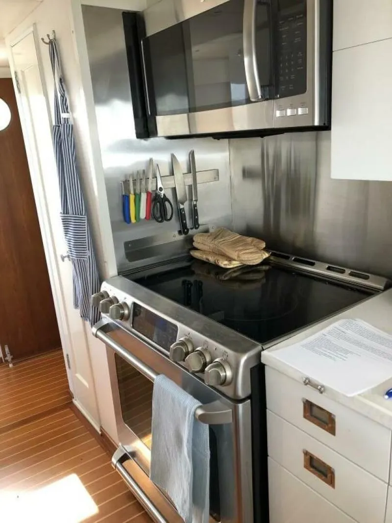 Slide: The Image of Modern kitchen in a 1972 Trumpy 72 Houseboat with stainless steel appliances. - 20