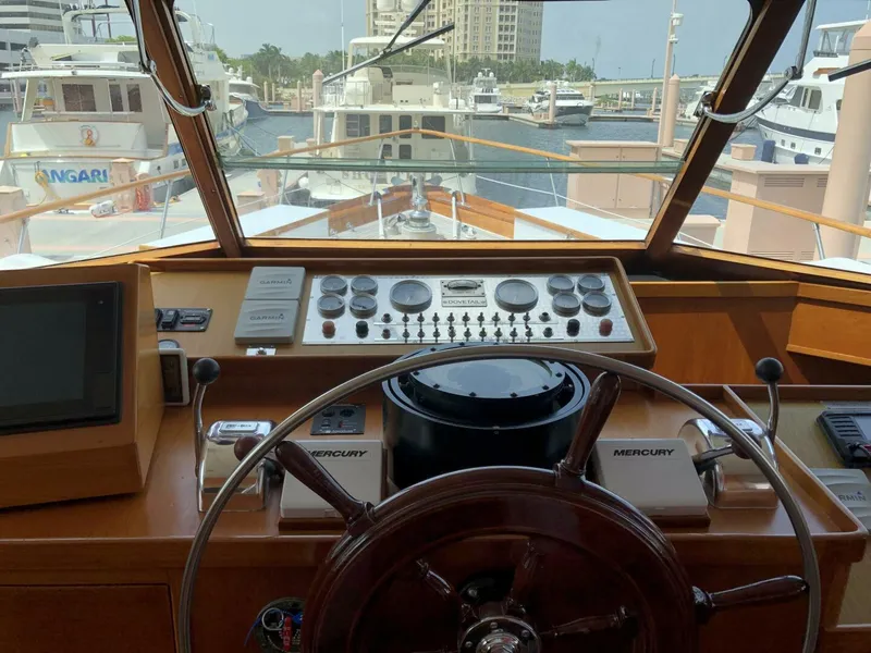 Slide: The Image of Helm of a 1972 Trumpy 72 Houseboat docked at a marina. - 21