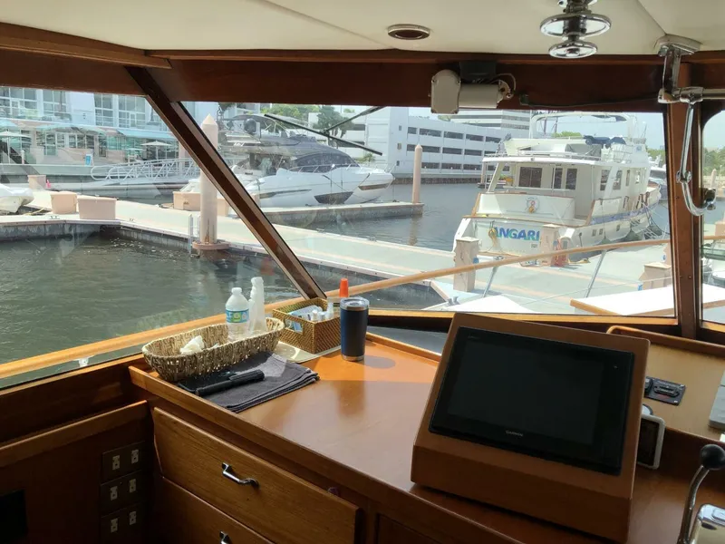 Slide: The Image of View from the helm of a 1972 Trumpy 72 Houseboat docked at a marina. - 22
