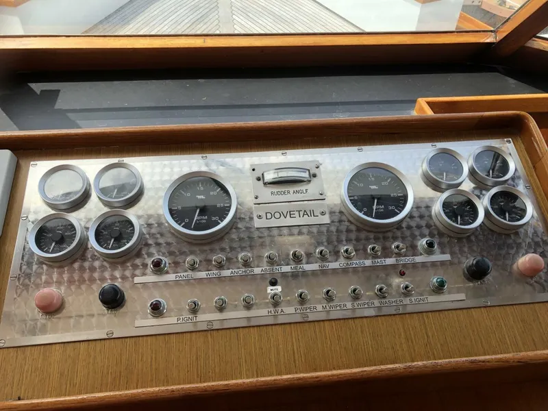 Slide: The Image of Control panel of a 1972 Trumpy 72 Houseboat with various gauges and switches. - 23