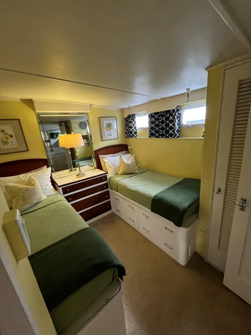 Slide: The Image of Cozy bedroom in a 1972 Trumpy 72 Houseboat with twin beds and modern decor. - 28