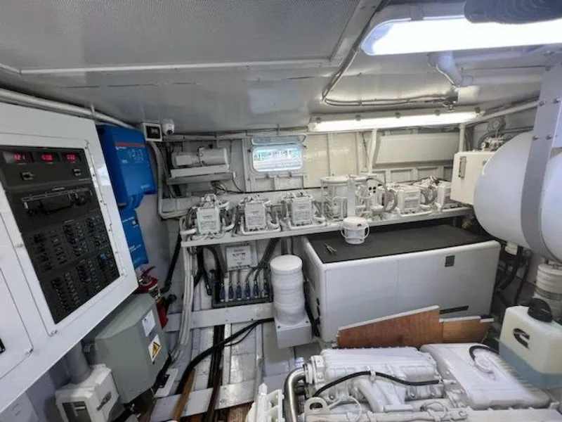 Slide: The Image of Engine room of a 1972 Trumpy 72 Houseboat with control panels and machinery. - 32