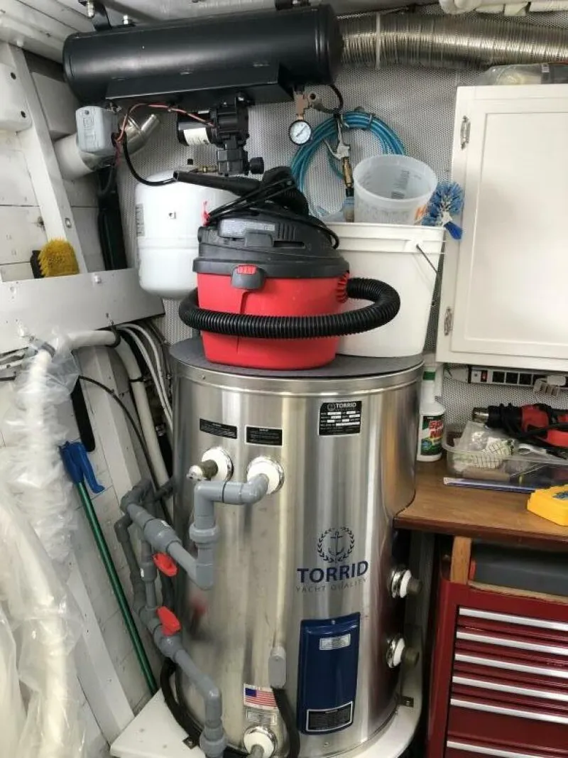 Slide: The Image of Engine room of 1972 Trumpy 72 Houseboat with Torrid water heater and vacuum. - 35