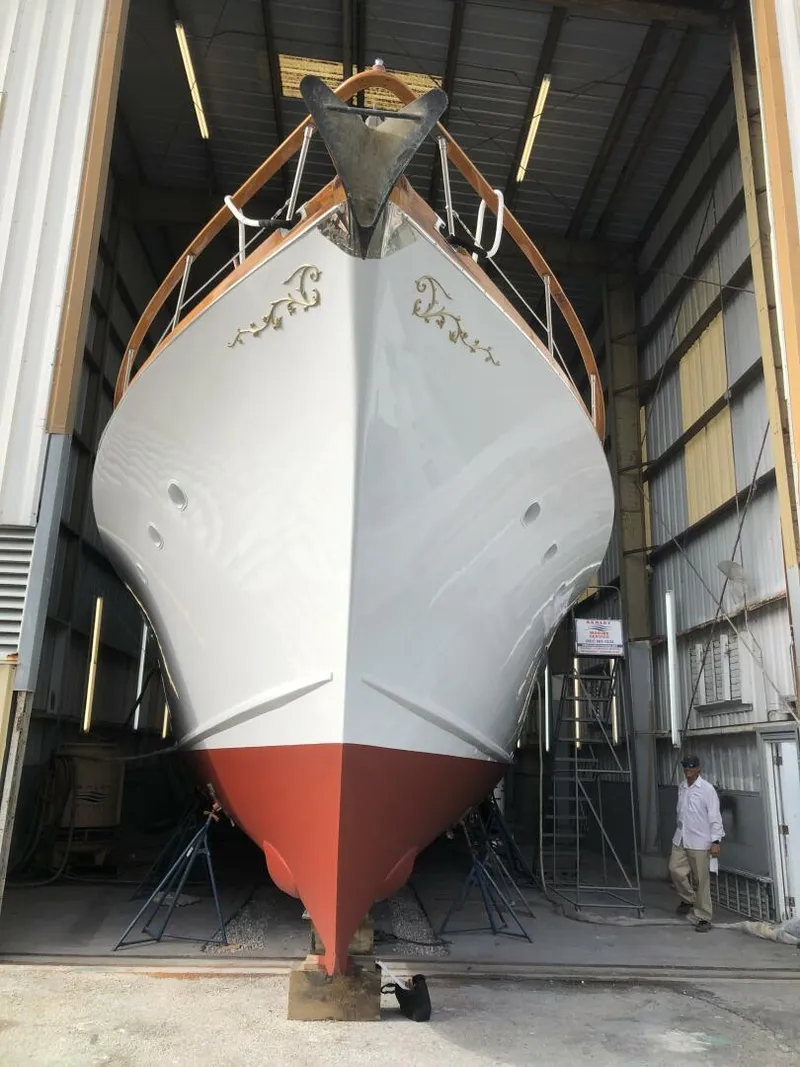 Slide: The Image of 1972 Trumpy 72 Houseboat in a boatyard for maintenance. - 4