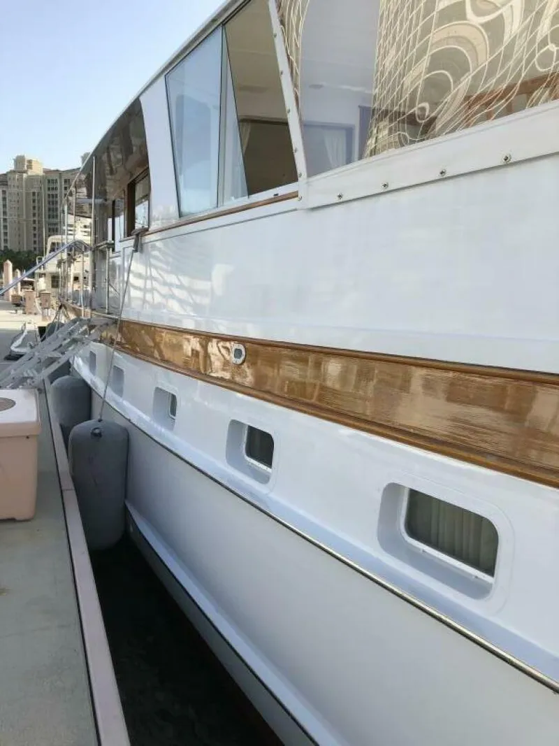Slide: The Image of 1972 Trumpy 72 Houseboat docked at marina. - 7