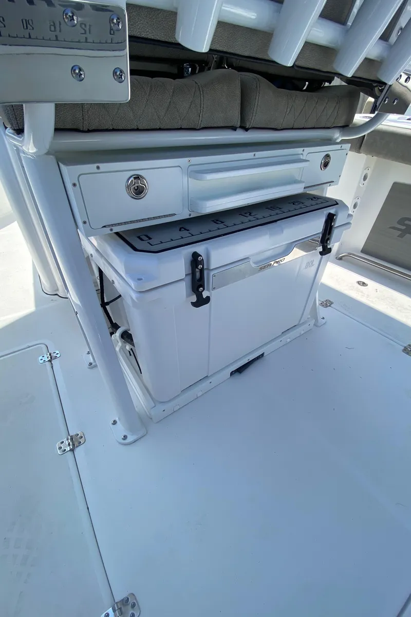 Slide: The Image of 2023 Sea Pro 259 boat interior with storage compartment and cooler. - 11