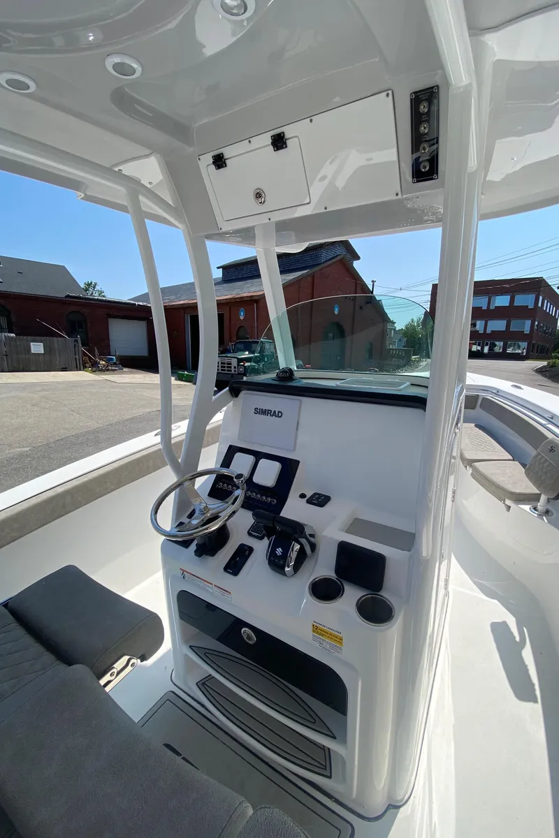 Slide: The Image of 2023 Sea Pro 259 boat console with modern navigation equipment and controls. - 12
