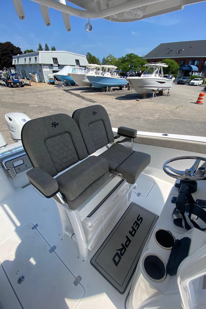 Slide: The Image of 2023 Sea Pro 259 boat interior with dual seats and helm station. - 13