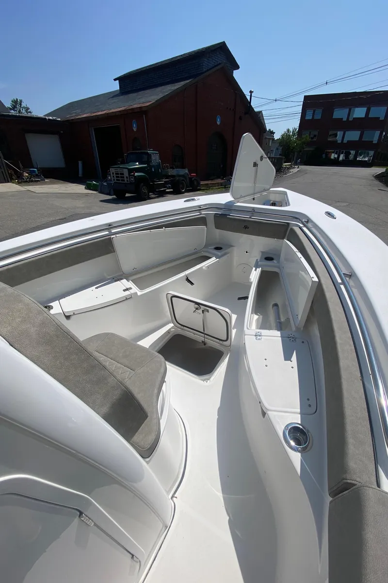 Slide: The Image of 2023 Sea Pro 259 boat interior with seating and storage compartments. - 14