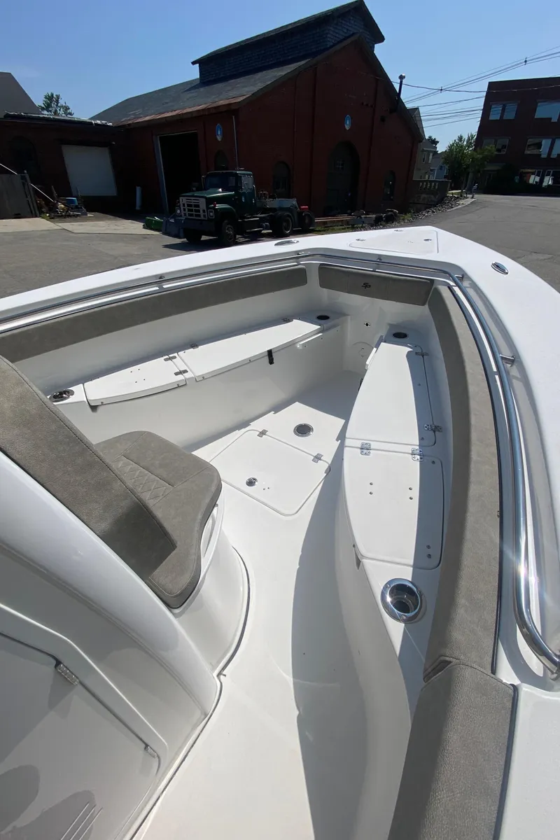 Slide: The Image of 2023 Sea Pro 259 boat with spacious seating and storage compartments. - 15