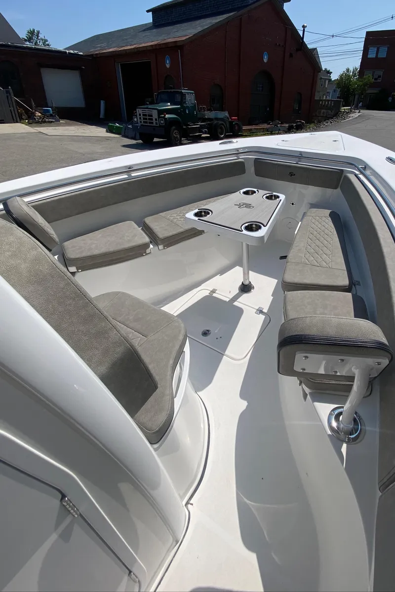 Slide: The Image of 2023 Sea Pro 259 boat interior with seating and table. - 16
