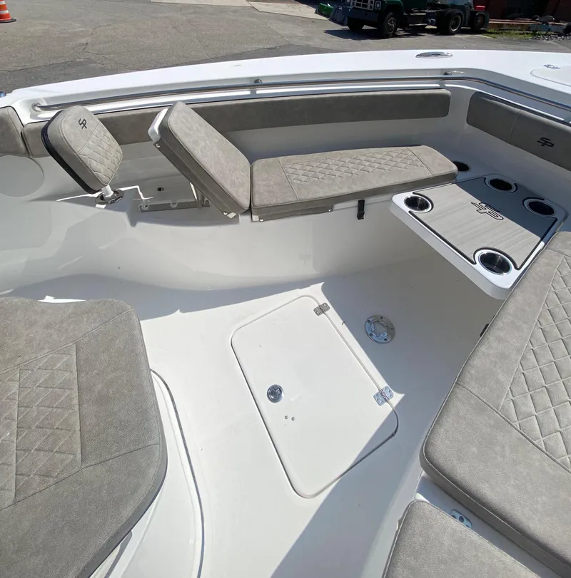 Slide: The Image of 2023 Sea Pro 259 boat interior with cushioned seating and storage compartments. - 17